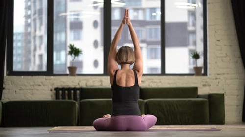 Woman Doing Yoga in Bright Apartment