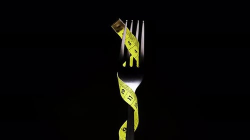 Fork and Measuring Tape Symbolize Dieting