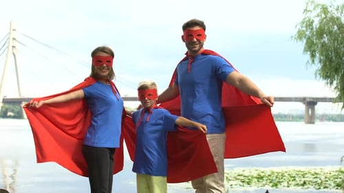 Family Superheroes Posing near River on Bright Day