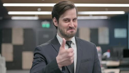 Man in Business Suit Gives Thumbs Up
