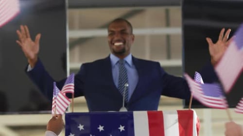 Smiling Man Giving Speech at Political Rally