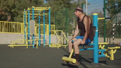 Active Senior Elderly Caucasian Man Do Physical Exercises in Sport Playground. Fitness Leisure