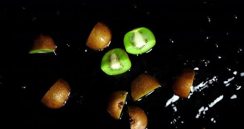 Ripe Kiwi Slices Splashing in Water
