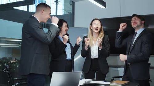 Successful business team celebrating victory in office
