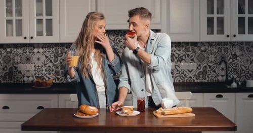Loving Couple Sharing Breakfast in Kitchen