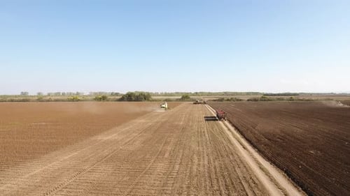 Aerial View of Tractors Working a Farm Field