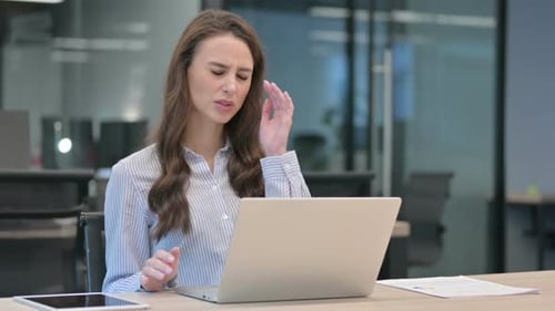 Stressed Young Adult Woman Working on Laptop