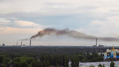 Cityscape on Summer Day with Residential District and Plant on a Background Filmed in Timelapse