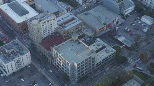 AERIAL: Downtown Air View of Parking Lot in Los Angeles, California Skyline at Beautiful Blue Sky