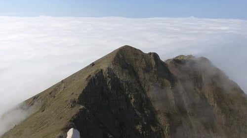 Sharp Mountain Ridge Over the Clouds