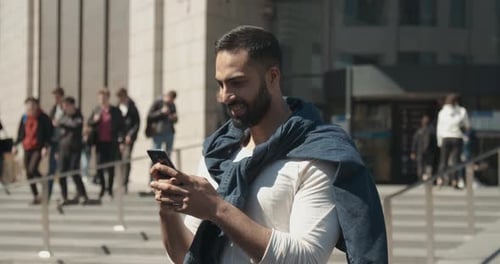 Young Adult Texting Outdoors in Urban Setting