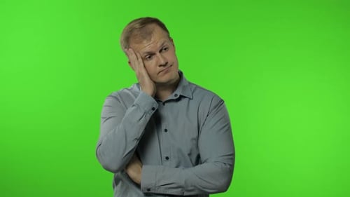 Sleepy Bored Guy Looking at Camera Not Interested in Communication. Man on Chroma Key Background