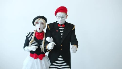 Mime Artists Performing Against a White Backdrop