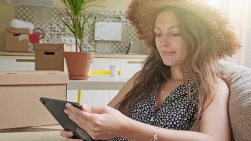 Woman Using Tablet at Home in Sunny Room