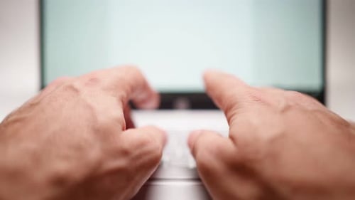 Closeup Male Hands are Typing on the Laptop Keyboard