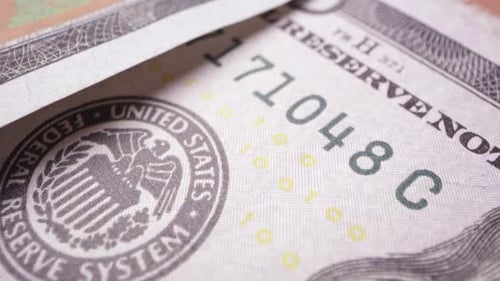 Macro view moving over top of 100 dollar bills