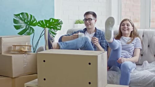 Tired Couple Resting in New Flat