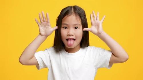 Child Making Silly Face with Tongue Out