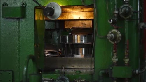 Workers Put Details in a Press Machine