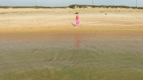 Young Woman Jog At Sand Sea Coast