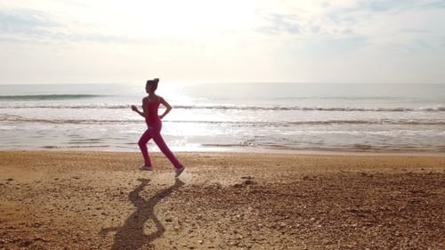 Young Woman Jog At Sand Sea Coast