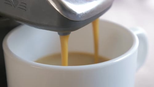 Espresso Machine Dispensing Coffee into Mug Close Up