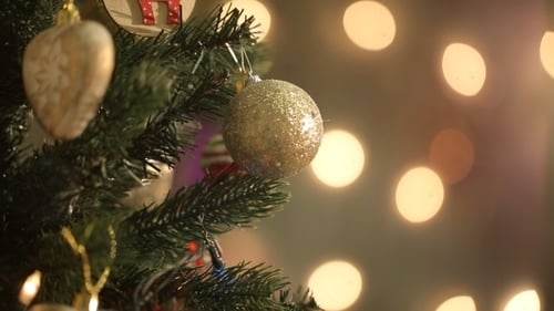 Decorating a Christmas Tree With Silver Ornament