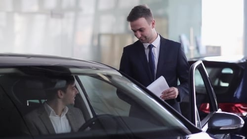 Man Buying New Car at Car Dealership