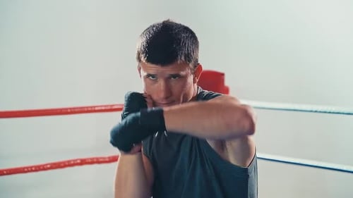 Young Man Practicing Boxing Punches in Ring