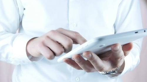 Man using white tablet device close up