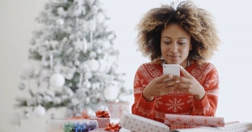 Young African Woman Checking For Xmas Messages