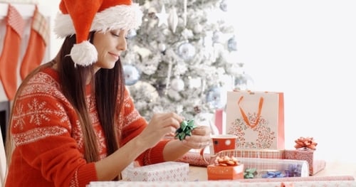 Woman Wrapping Christmas Presents at Home