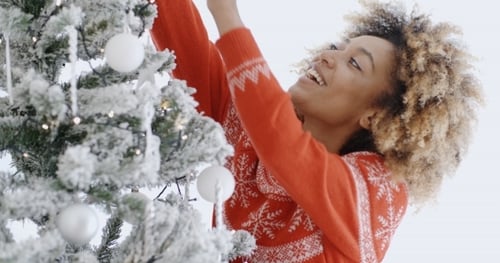 Young Adult Decorating a Christmas Tree