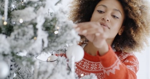 Woman Decorating Christmas Tree in a Close-Up Shot