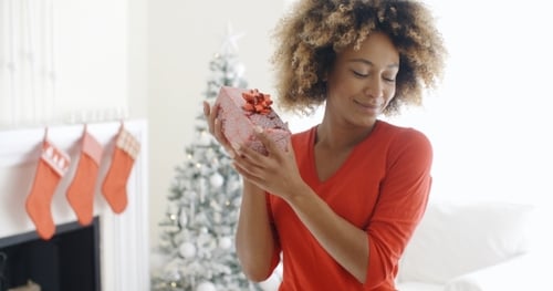 Blissful Happy Young Woman Holds a Christmas Gift
