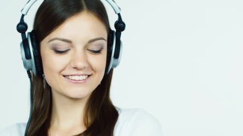 Young Adult Woman Listening to Music with Headphones
