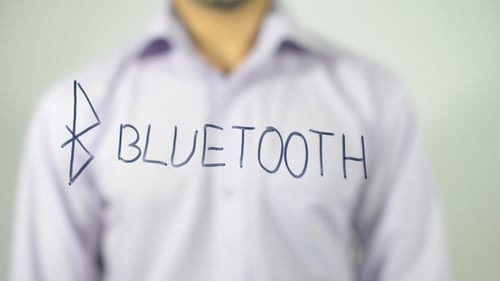 Writing 'Bluetooth' on Clear Surface with Black Marker