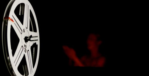Film Reel Spinning with Film Projected Behind
