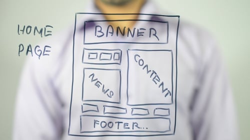 Adult Drawing a Website Wireframe on Glass