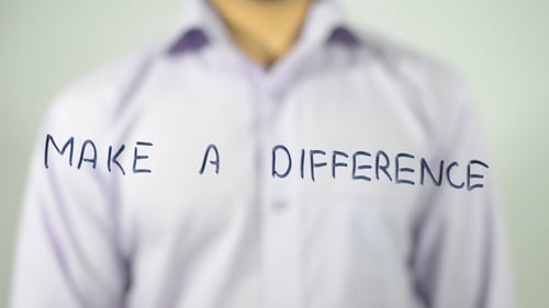 Man Writes 'Make a Difference' on Clear Surface