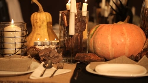 Autumn Table Setting with Pumpkins and Candlelight
