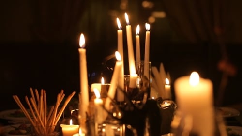 Burning Candles and Halloween Decorations on Table