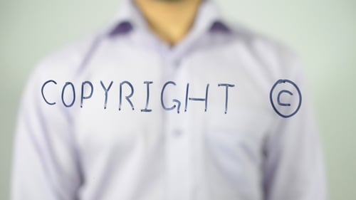 Hand Writing Copyright Symbol and Word on Glass