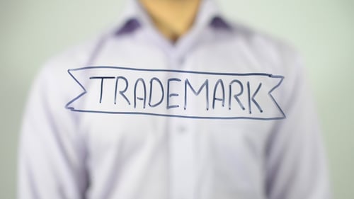 Writing Trademark on Clear Surface with Black Pen