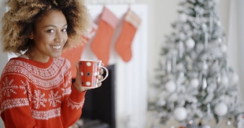 Smiling Woman with Christmas Sweater and Holiday Decorations