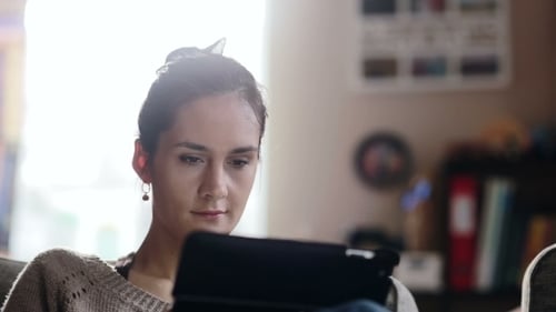 Woman Using Tablet Device at Home