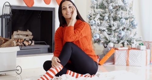 Woman in Red Sweater by Christmas Tree