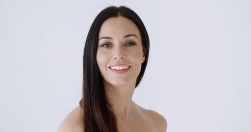 Attractive Woman Smiles Gently in a Studio