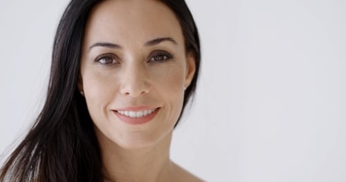 Woman Smiling Serenely in Close-Up Beauty Portrait