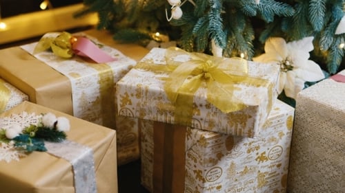 Festive Gifts Beneath Decorated Christmas Tree at Night